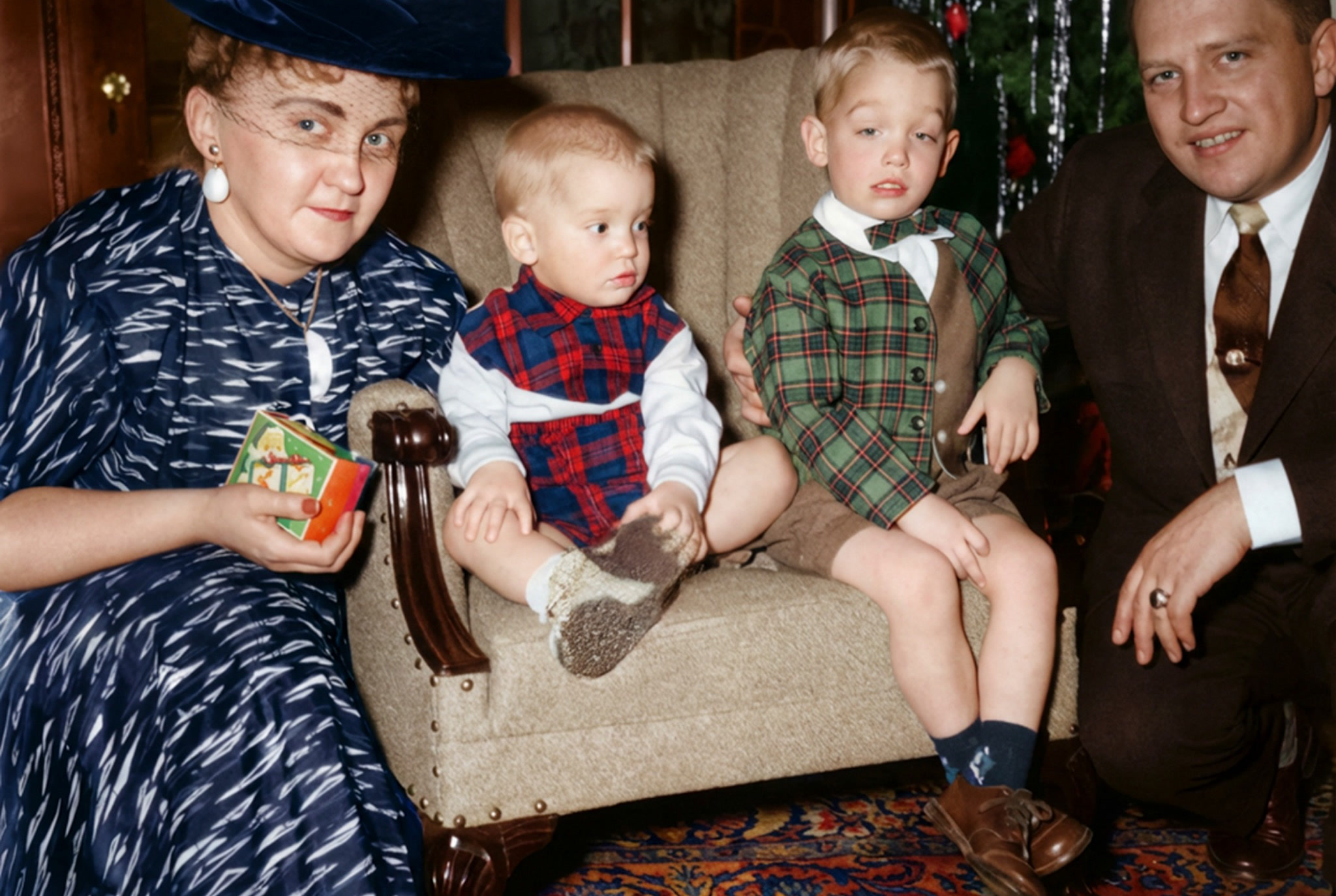 The restored color family photograph with repaired details and natural period color